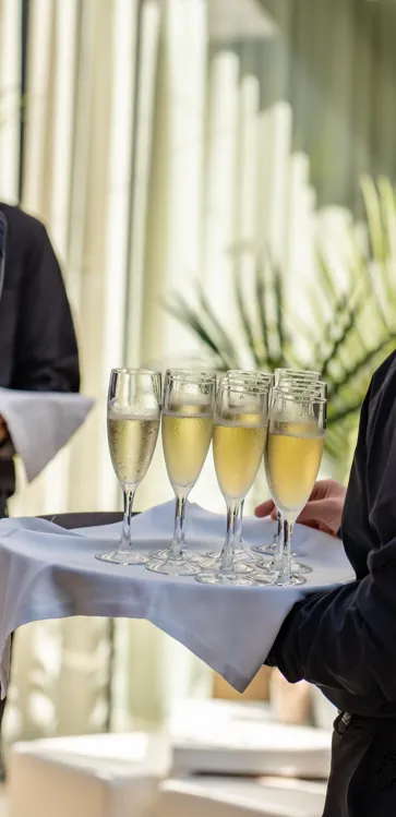 Camarero sirviendo bandeja de cava al aperitivo